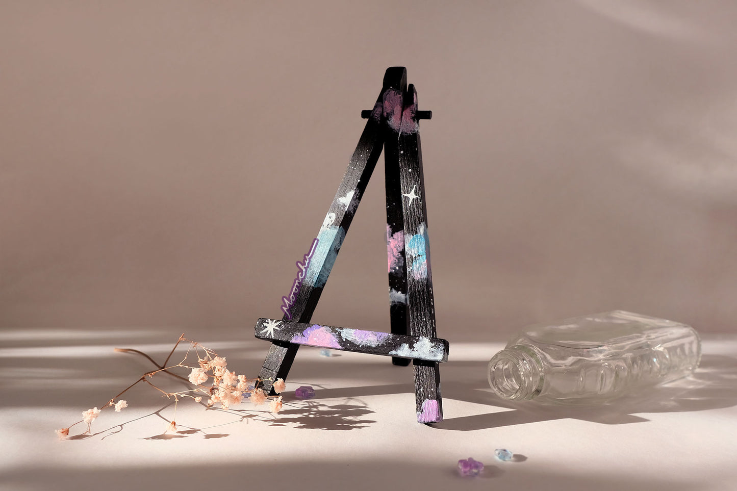 starry night add-on easel option, hand-painted by moonchu. base is black with teal, purple, and pink clouds with white twinkling stars.