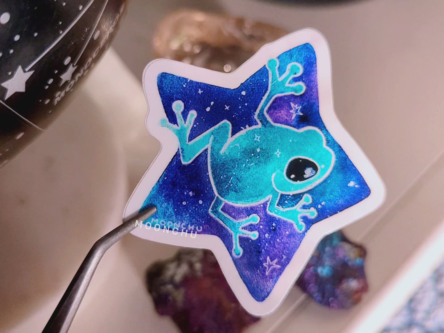 video showcasing vibrant blue and teal glossy frog sticker.