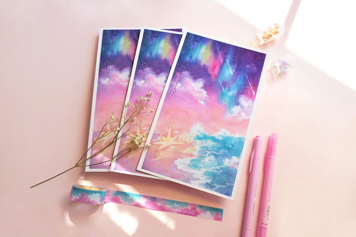 photo showcases a high quality art print of an original ink and watercolour ocean sky painting by moonchu. the illustration is very colourful with aurora and stars falling upon an ocean tide. a large, glowing star has fallen upon the beach. or washed ashore. up to you. sky gradients from purple to pink to light orange. a pretty dreamy art piece.