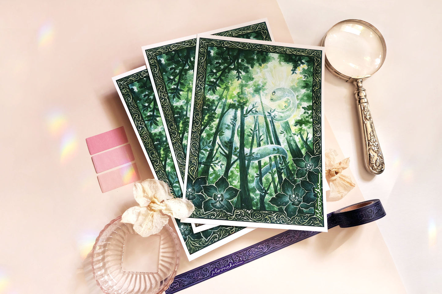 original mixed media art painting by moonchu depicting a lush, verdant snake winding through tall tree trunks. has an elaborate border with intricate dark green orchids framing the lower left and right. lunar new year art for growth inspiration, or if you are a snake lover or botanical friend. very green aesthetic, wooded forest illustration.