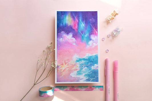 photo showcases a high quality art print of an original ink and watercolour ocean sky painting by moonchu. the illustration is very colourful with aurora and stars falling upon an ocean tide. a large, glowing star has fallen upon the beach. or washed ashore. up to you. sky gradients from purple to pink to light orange. a pretty dreamy art piece.